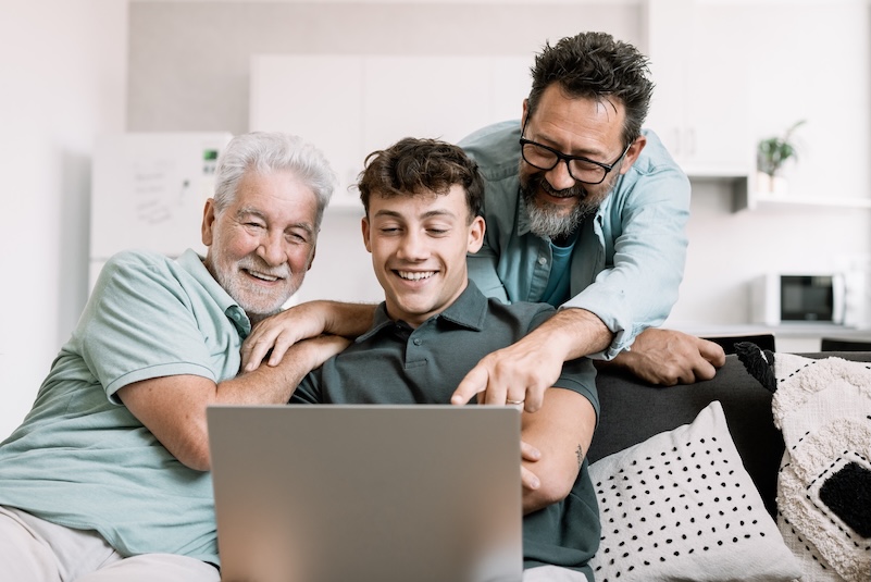 Three generations of men reviewing healthcare information together
